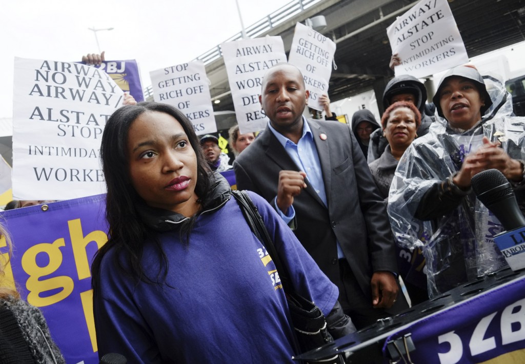 After airport workers at both JFK and LaGuardia protested against what they said are unfair - and even illegal - working conditions, the Port Authority moved to increase wages for the employees. JFK employee Shareeka Elliott, pictured here, was recently invited to the State of the Union address by U.S. Sen. Chuck Schumer after he read about her plight making $8 scrubbing floors at JFK during an all-night shift, after which she takes her two daughters to school.  File photo