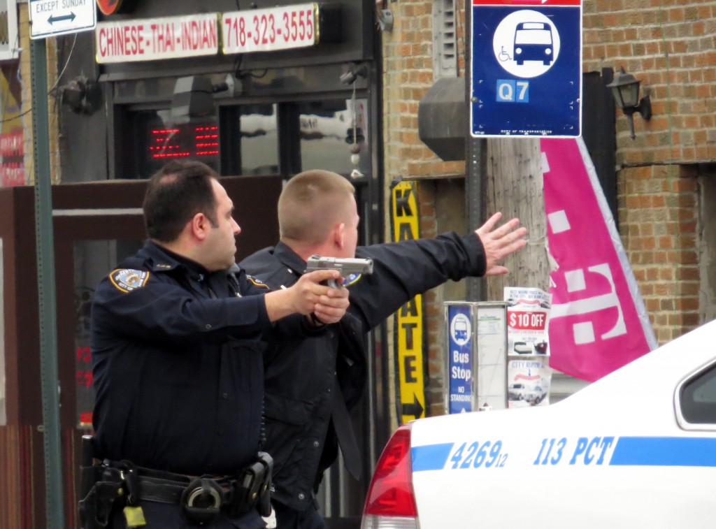  Police draw their weapons while in a standoff with a 33-year-old man who led them on a nearly four-mile chase in South Ozone Park last week.  Photos by Robert Stridiron