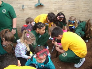 Christ the King students work hard on planting flowers and vegetables at their school.  Photo courtesy Christ the King Campus