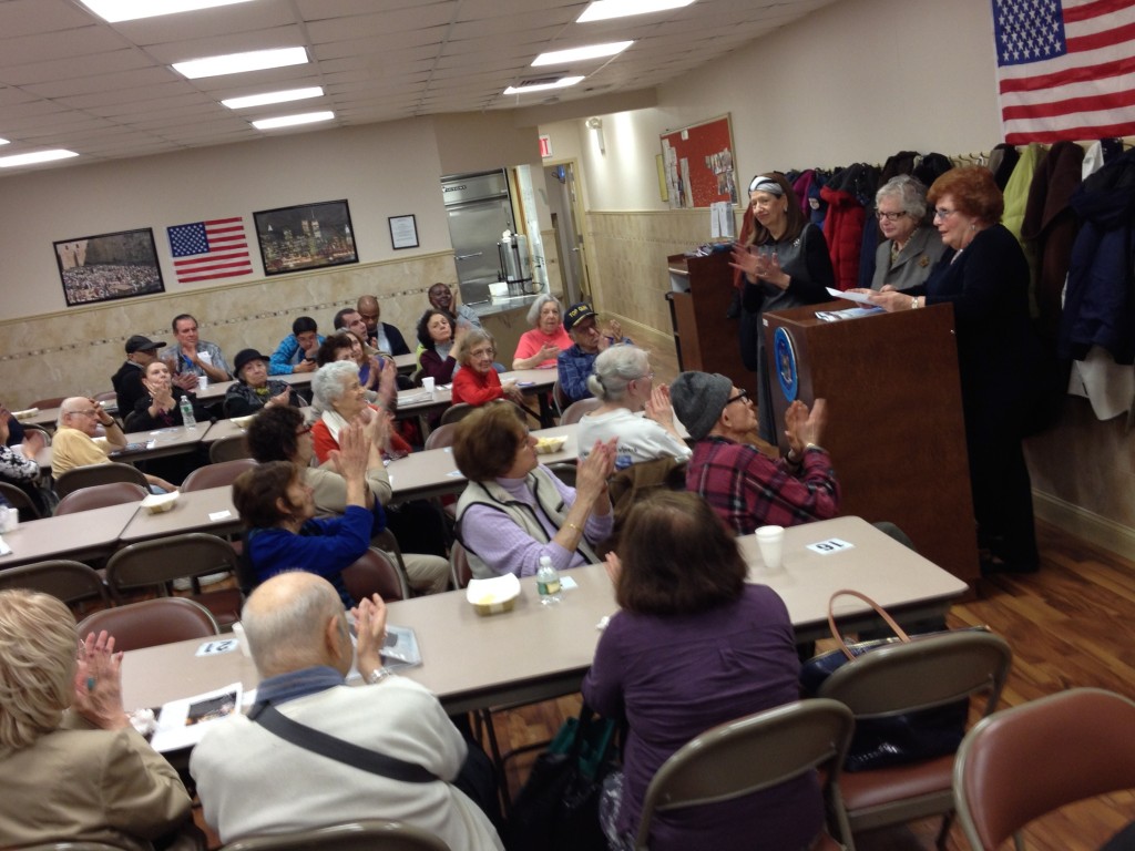 State Sen. Toby Stavisky, standing center, and Councilwoman Karen Koslowitz, standing right, speak about tax relief for seniors in Forest Hills. Photo by Phil Corso