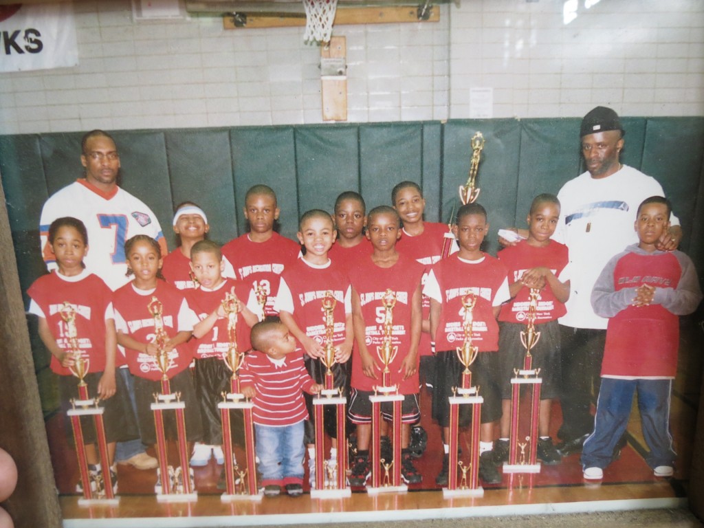 Gerald Gittens, fourth from left, almost grew up on the basketball court. Here he is at age three, spending time with a basketball team from St. John's Recreation Center.