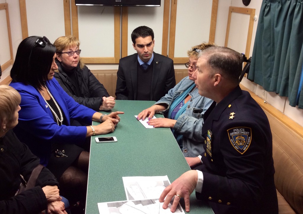 NYPD Deputy Chief David Barrere, the commanding officer of Patrol Borough Queens South, front right, discusses the Police Department's plans to fight crime in the Howard Beach area with Councilman Eric Ulrich, center; Howard Beach/Lindenwood Civic President Joann Ariola, second from left; and other civic leaders last week. Photo courtesy Councilman Eric Ulrich