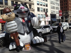 An inflatable "fat cat" strangling a UPS worker was set up outside City Hall last week. Photo by Phil Corso