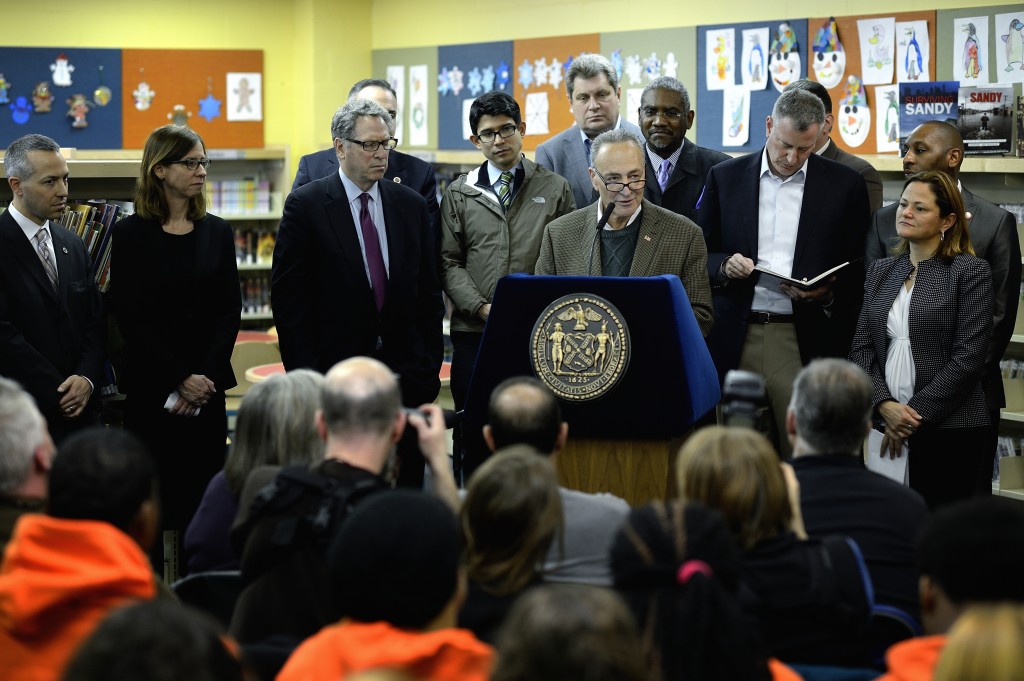 U.S. Sen. Chuck Schumer, center; Mayor Bill de Blasio, second from right; City Council Speaker Melissa Mark-Viverito, and others, announce at the Seaside Library in Rockaway on Saturday changes to the city's Hurricane Sandy aid programs. Photo courtesy NYC Mayor's Office