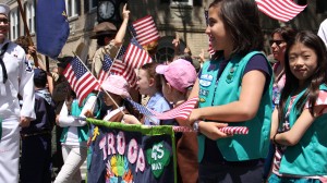 Girl Scouts wave their American flags at the crowds that gathered to cheer on the parade. Photos by Cesar R. Bustamante, Jr.