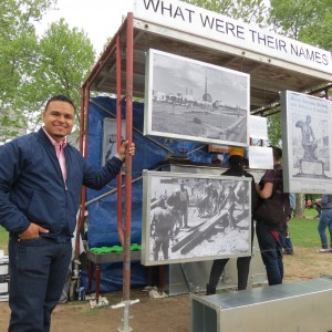 Jaime Lopez, a member of the Queens' Workers Coalition, stands by part of his group's art exhibit, "What Were Their Names," at Sunday's festival. The exhibit honored laborers - in general, as well as those who worked to construct the World's Fairs. "There's an invisibility with labor that we wanted show - we never reap the benefits of what we've created," Lopez said. for more information about the group, email Queensyoungworkers@gmail.com.  Photo by Anna Gustafson