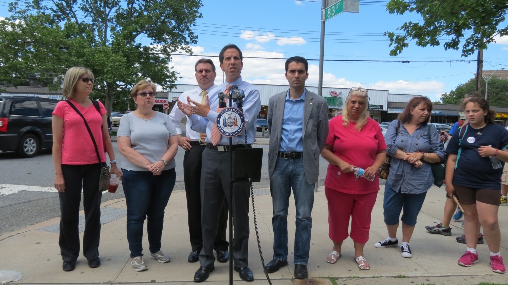 Assemblyman Phil Goldfeder, center at podium, state Sen. Joe Addabb Jr., left of Goldfeder, and Councilman Eric Ulrich, right of Goldfeder, join civic leaders and parents to call on the city Department of Transportation to address what they said is a litany of problems plaguing the streets surrounding PS 232.   Photo by Anna Gustafson 
