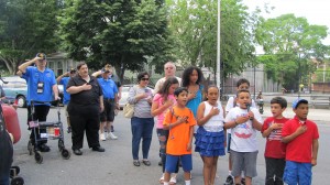 Assemblyman Mike Miller, second from left, and younger Woodhaven residents also honored the veterans Saturday, including, Mario Roldan, front left, Arianna Rivera, Marco Diaz, Nicky Diaz, Joel Rivera, Jessica Diaz, back left, Breanna Rivera, and Brandon Roldan. Here, the individuals are singing the "Star-Spangled Banner."  Photo courtesy Josephine Wendell
