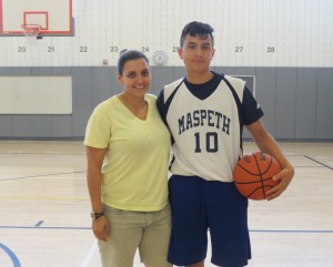 Maspeth H.S. Boys Varsity Coach Anastasia Bitis stands with Paolo Tamer, student/basketball athlete on the school's basketball court. Photo by Debbie Cohen