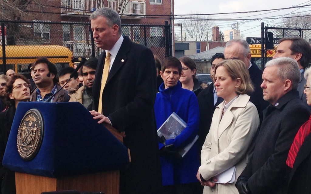 Mayor Bill de Blasio, at podium, joined Queens Borough President Melinda Katz, second from right, and others in Woodside in January to announce his Vision Zero initiative. The City Council just passed a sweeping package of bills as part of the Vision Zero plan, which aims to dramatically reduce pedestrian deaths.  File Photo