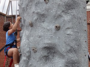 Abby Tavarez climbs the rock wall at last Thursday's Rising Stars Fun Day event in Howard Beach.  Photo by Phil Corso