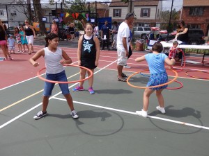 Howard Beach kids challenge each other to see who can hula-hoop the hardest.  Photo by Phil Corso