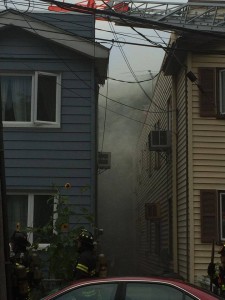 Smoke billows out from behind the Woodhaven home.  Photo courtey of Salvatore Izzy