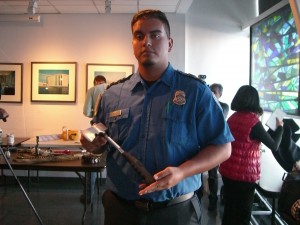 Transportation Security Officer Camilo Bernal displays a hatchet that was surrendered by a passenger at a JFK checkpoint.  Photo by Michael V. Cusenza