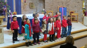 The kindergarten class delivered a rousing rendition of "Rudolph the Red-Nosed Reindeer." Forum Photo by Michael V. Cusenza