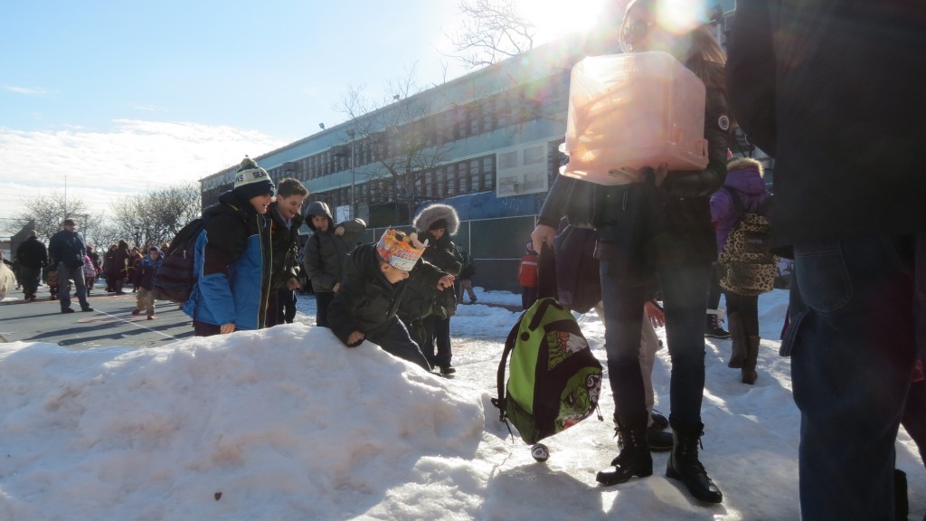 Ice in the schoolyard has made exiting PS 207 a problem for students and parents. Forum Photo by Michael V. Cusenza.