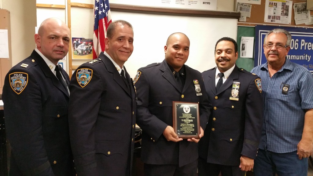 106th Precinct Cop of the Month Royce Poblete is congratulated by Capt. John Gancey,106 executive officer (l. to r.); NYPD Chief of Patrol Carlos Gomez; Dep. Inspector Jeffrey Schiff, commanding officer of the 106; and Precinct Community Council President Frank Dardani.