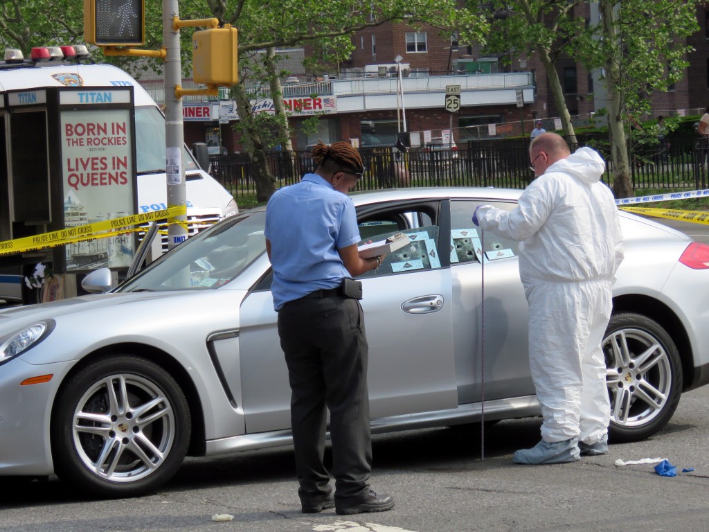  Crime Scene Unit investigators on Sunday collected evidence in and around the car rapper Chinx was driving when he was shot and killed on Queens Boulevard and 84th Drive. Forum Photo by Robert Stridiron.
