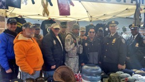  Deputy Inspector Deodat Urprasad, commanding officer of the 102nd Precinct (far r.); Asst. Chief David Barrere, commanding officer of Patrol Borough Queens South (second from r.); and 102nd Precinct Community Affairs Officer Eddie Martinez (far l.) thanked some military veterans last Sunday at the festival for their service to the country.   