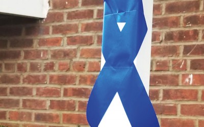 Finest-Supporting Residents Tie Blue Ribbon  Around Howard Beach