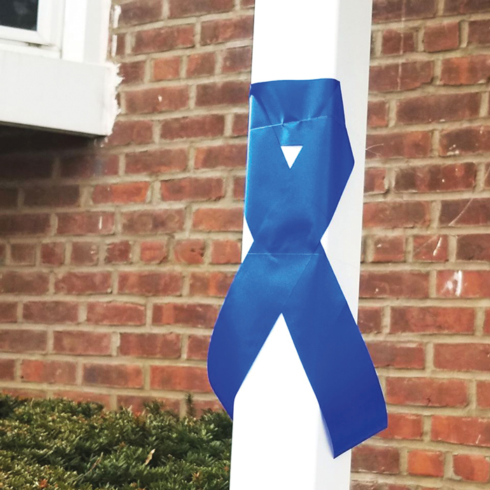 Finest-Supporting Residents Tie Blue Ribbon  Around Howard Beach