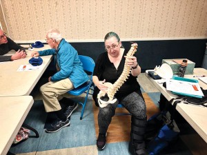 Photo Courtesy of Sen. Addabbo Dr. Yoshihara displays a model of a vertebra with a bulging disc.